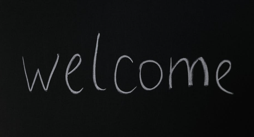 "welcome" written in white chalk on a chalkboard